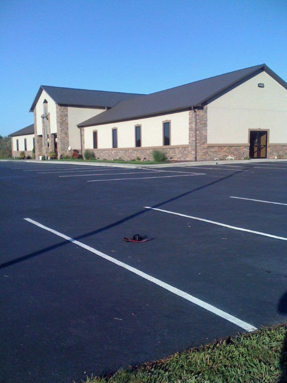 A large building with a parking lot in front of it