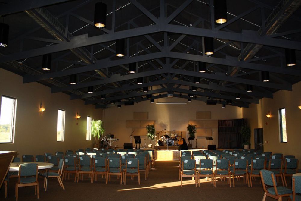 A large room with lots of chairs and tables