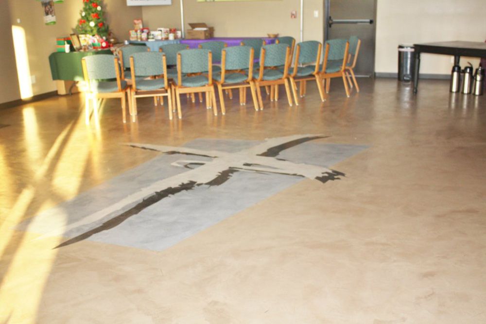 A room with chairs and a cross on the floor