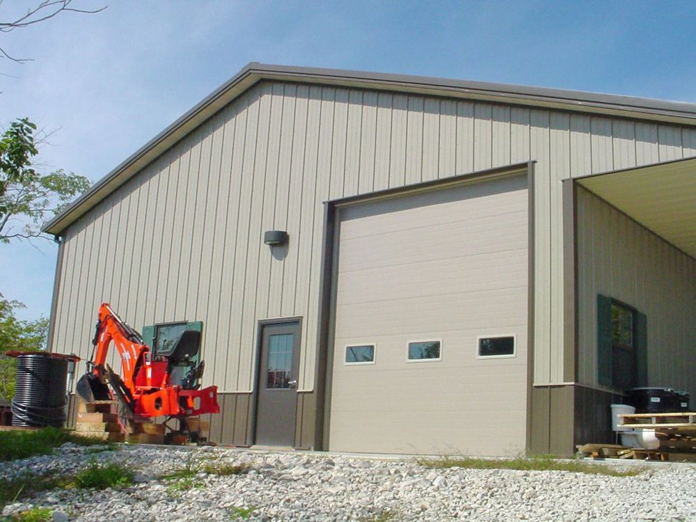 A large metal building with a large garage door