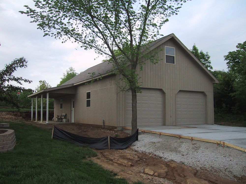 A garage with two garage doors and a porch