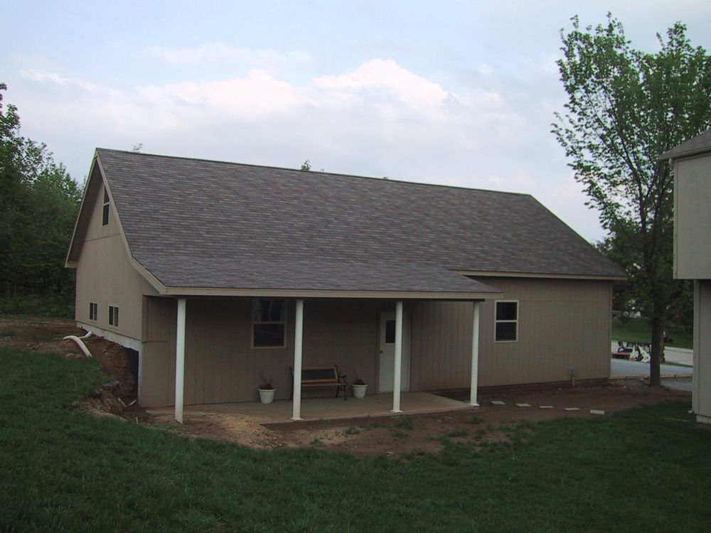 A house with a porch and a gray roof
